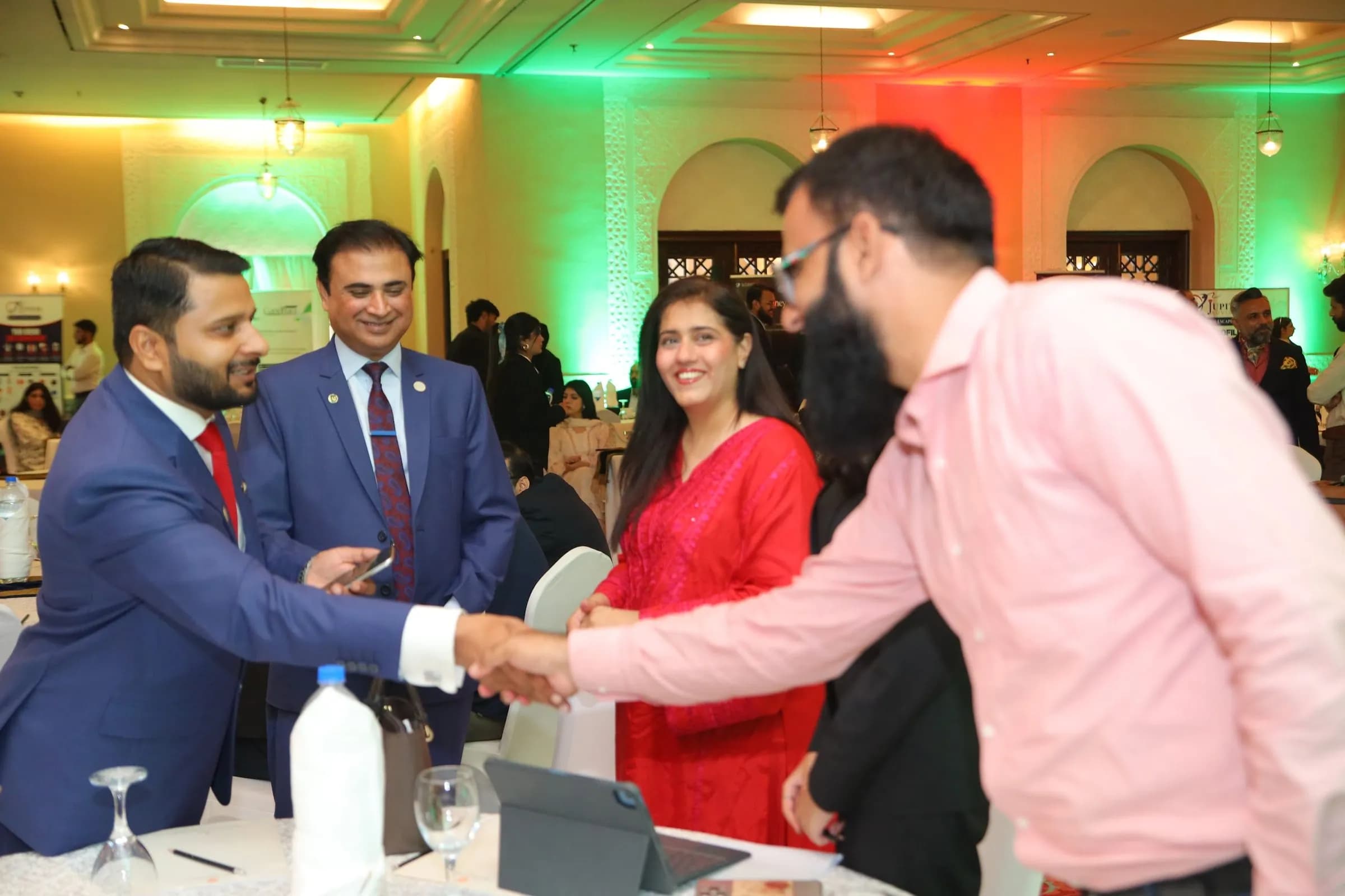 Delegates shaking hands at a networking table at PBLS Serena Islamabad